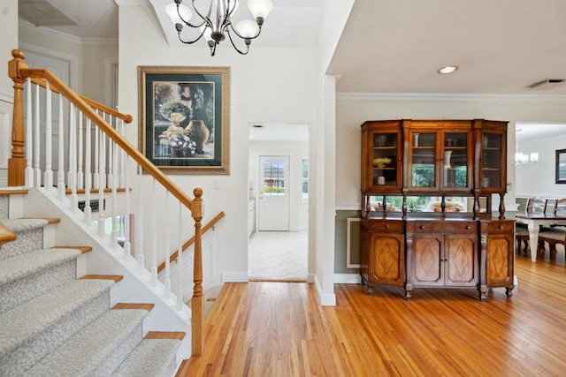 5 Coventry Rd, Syosset, NY 11791 - foyer featuring a chandelier, light wood-style floors, stairs, crown molding, and baseboards