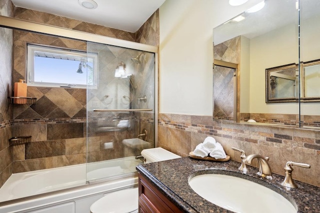 5 Coventry Rd, Syosset, NY 11791 - full bathroom featuring vanity, toilet, tile walls, and bath / shower combo with glass door