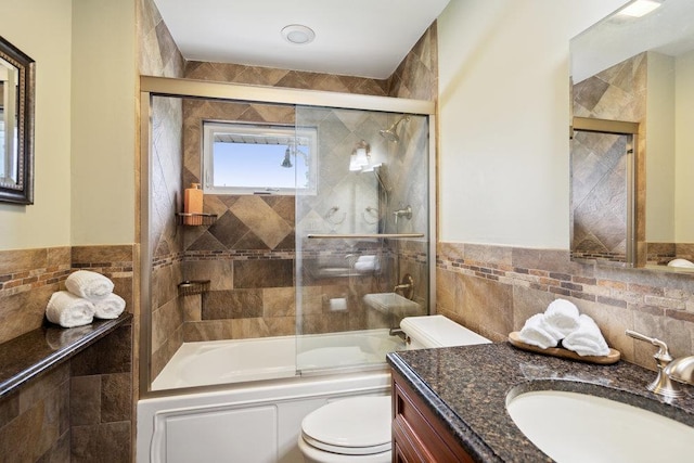 5 Coventry Rd, Syosset, NY 11791 - bathroom with tile walls, vanity, toilet, combined bath / shower with glass door, and wainscoting
