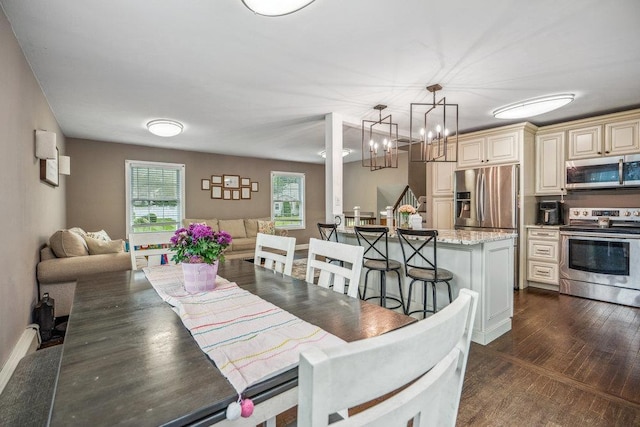 12 Pleasant Pl, Farmingville, NY 11738 - dining room with a chandelier, dark wood-style floors, and baseboards