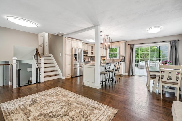 12 Pleasant Pl, Farmingville, NY 11738 - kitchen featuring stainless steel appliances, cream cabinets, a sink, and a kitchen island