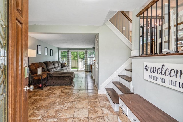 12 Pleasant Pl, Farmingville, NY 11738 - living room featuring stairs, light stone finish flooring, and baseboards