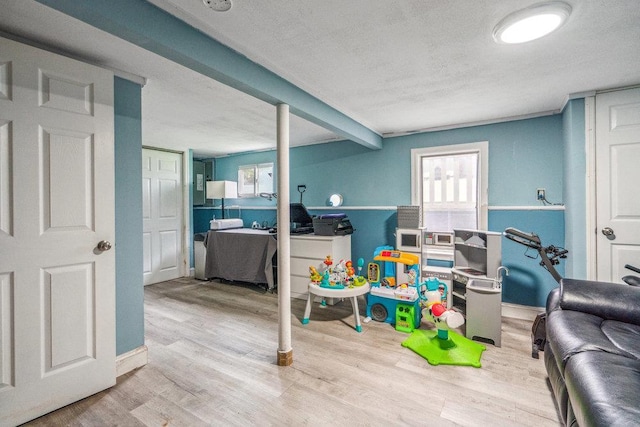 12 Pleasant Pl, Farmingville, NY 11738 - playroom featuring wood finished floors, a textured ceiling, and an office area