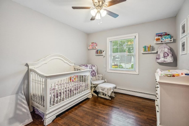 12 Pleasant Pl, Farmingville, NY 11738 - bedroom with a baseboard radiator, wood finished floors, a crib, and a ceiling fan