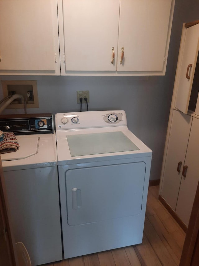 1502 Evergreen Ct, Highland Mills, NY 10930 - washroom featuring washing machine and clothes dryer, cabinet space, and wood finished floors