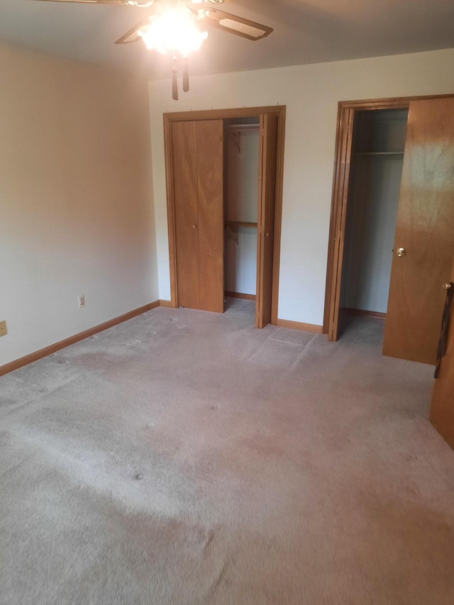1502 Evergreen Ct, Highland Mills, NY 10930 - unfurnished bedroom featuring two closets, light colored carpet, baseboards, and ceiling fan