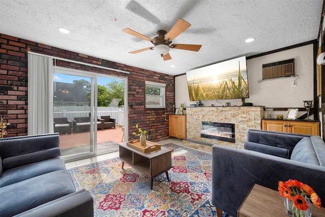 21 Westgate Rd, Massapequa Park, NY 11762 - living area featuring brick wall, ceiling fan, a textured ceiling, light tile patterned floors, and a glass covered fireplace