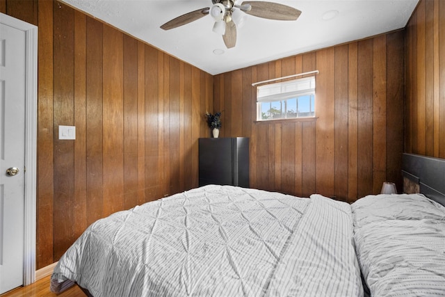 21 Westgate Rd, Massapequa Park, NY 11762 - bedroom with wood walls, a ceiling fan, and wood finished floors