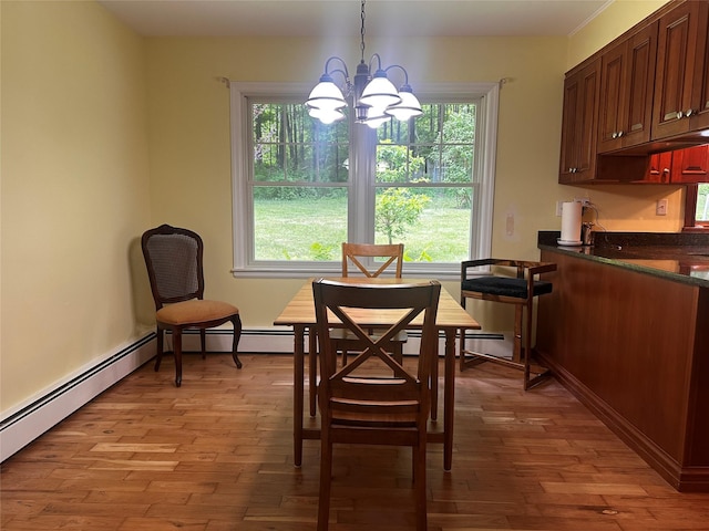 287 Hunns Lake Rd, Stanfordville, NY 12581 - dining space with a chandelier, light wood finished floors, and a baseboard heating unit