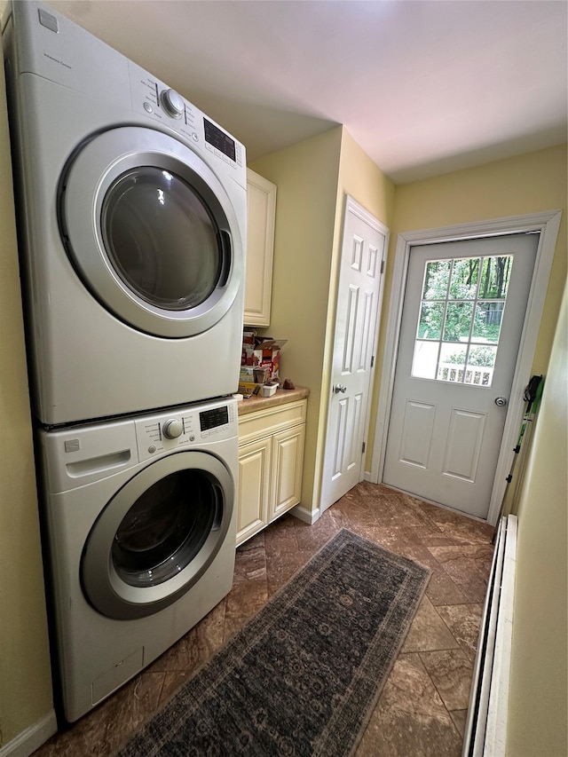 287 Hunns Lake Rd, Stanfordville, NY 12581 - washroom featuring stacked washer and clothes dryer, cabinet space, and baseboards
