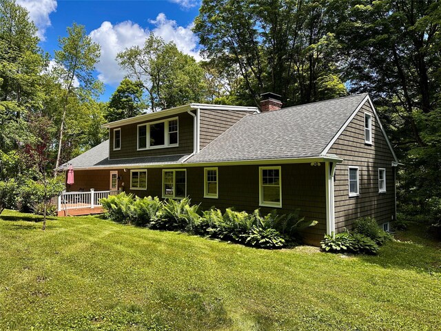 287 Hunns Lake Rd, Stanfordville, NY 12581 - view of front facade with a shingled roof, a chimney, a front yard, and a wooden deck