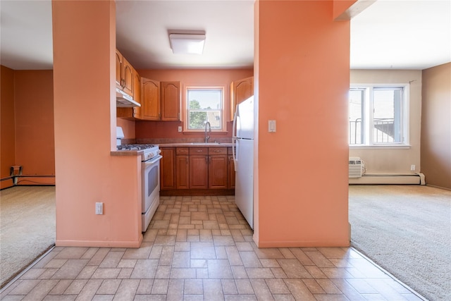 200 Centre Ave Unit 3B, New Rochelle, NY 10805 - kitchen with white appliances, a sink, under cabinet range hood, baseboard heating, and light countertops