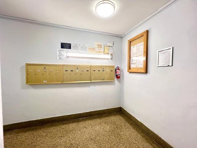 215-19 48th Ave Unit 3C, Bayside, NY 11364 - unfurnished room featuring mail area, speckled floor, and baseboards
