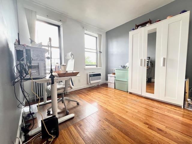215-19 48th Ave Unit 3C, Bayside, NY 11364 - home office with a wall mounted air conditioner and wood finished floors
