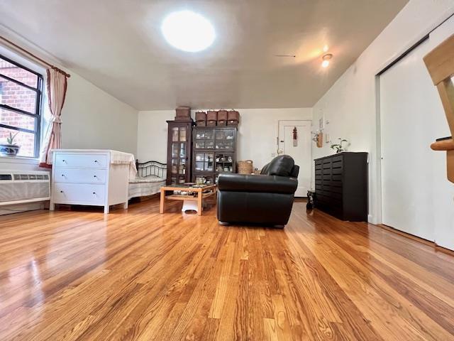 215-19 48th Ave Unit 3C, Bayside, NY 11364 - living area with wood finished floors and a wall unit AC