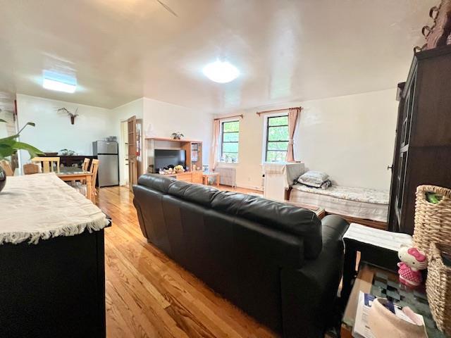 215-19 48th Ave Unit 3C, Bayside, NY 11364 - living room with light wood-style floors