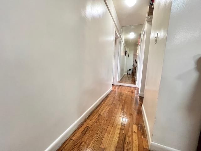 215-19 48th Ave Unit 3C, Bayside, NY 11364 - hall featuring attic access, hardwood / wood-style floors, and baseboards