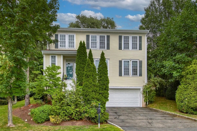 36 Bellefair Rd, Rye Brook, NY 10573 - view of front facade featuring asphalt driveway and a garage