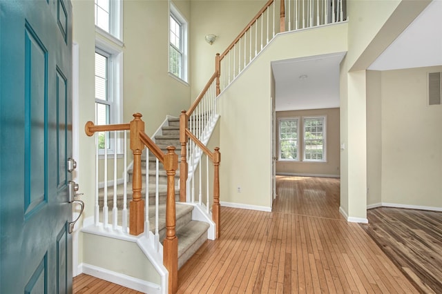 36 Bellefair Rd, Rye Brook, NY 10573 - foyer entrance with light wood-type flooring, stairway, and a high ceiling