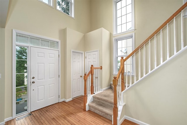 36 Bellefair Rd, Rye Brook, NY 10573 - entryway with stairs, healthy amount of natural light, a high ceiling, and light wood-style floors