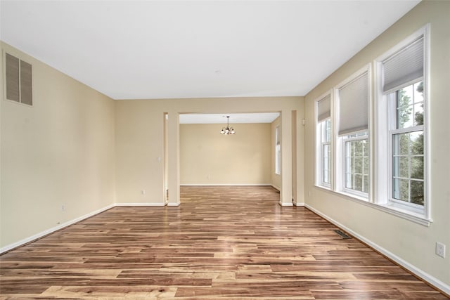 36 Bellefair Rd, Rye Brook, NY 10573 - unfurnished room featuring a chandelier and wood finished floors