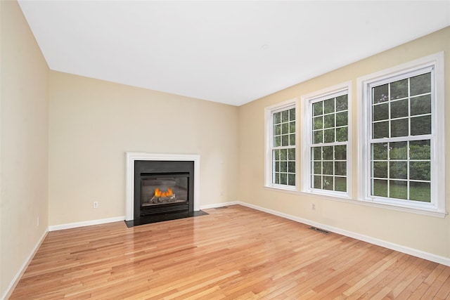 36 Bellefair Rd, Rye Brook, NY 10573 - unfurnished living room featuring light wood-style floors and a fireplace with flush hearth