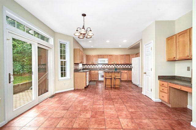 36 Bellefair Rd, Rye Brook, NY 10573 - kitchen featuring a chandelier, white appliances, decorative backsplash, a kitchen island, and dark countertops