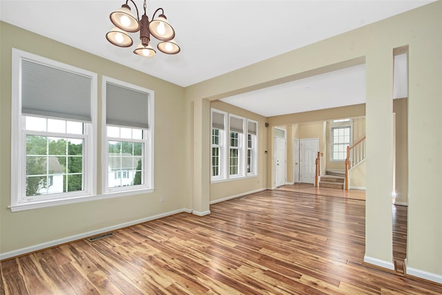 36 Bellefair Rd, Rye Brook, NY 10573 - unfurnished room with stairs, wood finished floors, and a chandelier