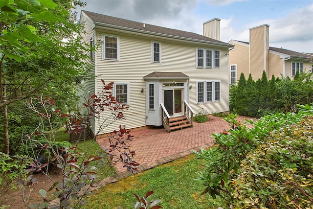36 Bellefair Rd, Rye Brook, NY 10573 - rear view of house with entry steps, a patio area, and a chimney