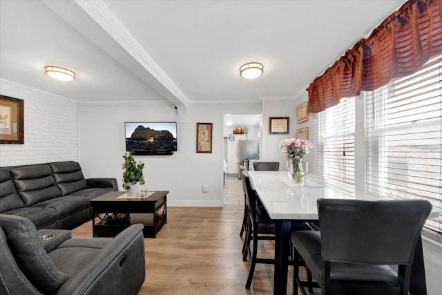 735 E 216th St, Bronx, NY 10467 - dining area featuring crown molding, baseboards, wood finished floors, and brick wall