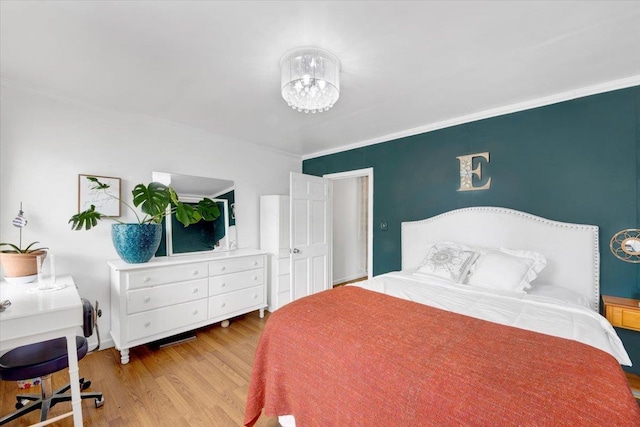 735 E 216th St, Bronx, NY 10467 - bedroom with wood finished floors, crown molding, and a chandelier