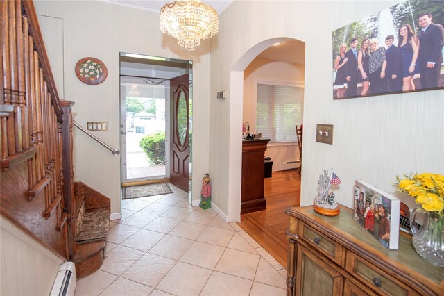 1053 Quentin Pl, Woodmere, NY 11598 - foyer entrance featuring healthy amount of natural light, light tile patterned floors, stairs, and arched walkways