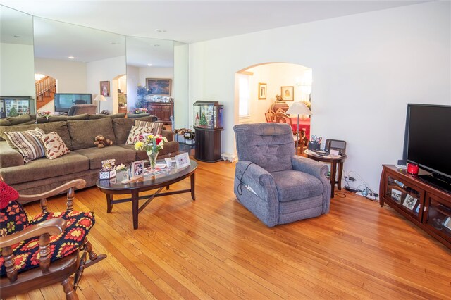 1053 Quentin Pl, Woodmere, NY 11598 - living room with arched walkways, light wood-style floors, and stairway