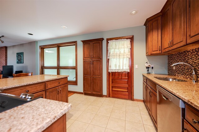 1158 Lorraine Dr, Franklin Square, NY 11010 - kitchen featuring stainless steel dishwasher, a sink, decorative backsplash, light stone counters, and light tile patterned flooring