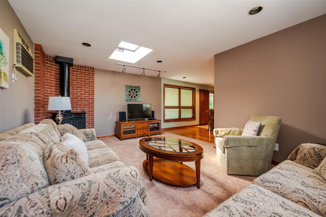 1158 Lorraine Dr, Franklin Square, NY 11010 - living room featuring a skylight, a wood stove, carpet flooring, and recessed lighting