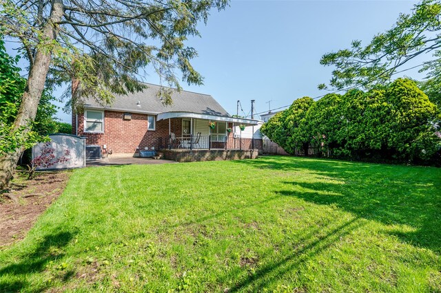 1158 Lorraine Dr, Franklin Square, NY 11010 - rear view of house featuring brick siding, central air condition unit, and a porch