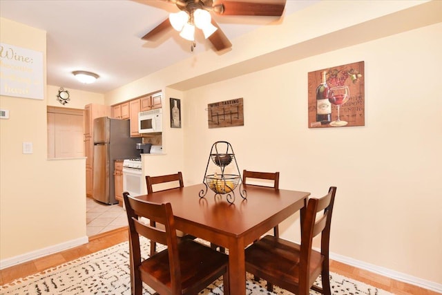 320 E Shore Rd Unit 10C, Great Neck, NY 11023 - dining area with ceiling fan and light wood-style flooring