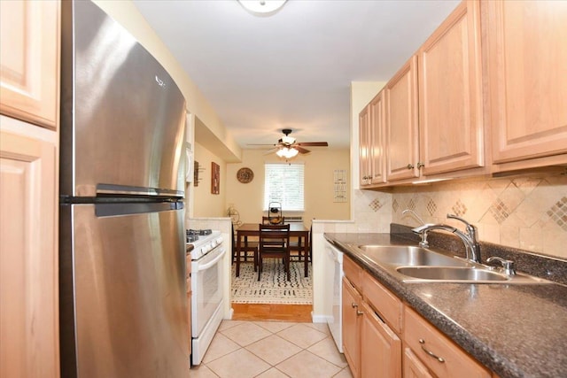 320 E Shore Rd Unit 10C, Great Neck, NY 11023 - kitchen with white appliances, light brown cabinets, dark countertops, and light tile patterned flooring