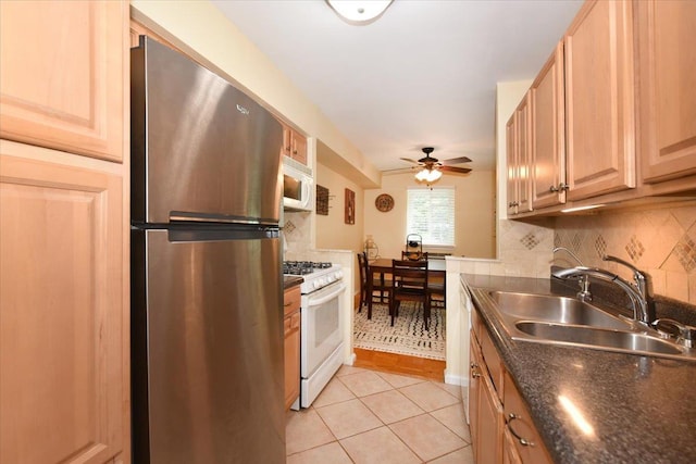 320 E Shore Rd Unit 10C, Great Neck, NY 11023 - kitchen with white appliances, a ceiling fan, tasteful backsplash, light tile patterned floors, and light brown cabinetry