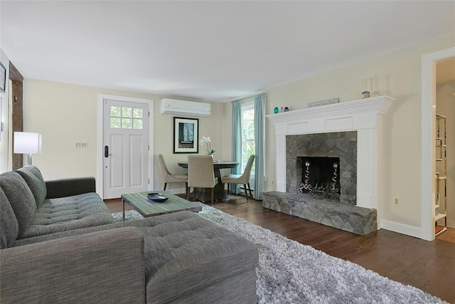 1 Lakeview Rd, South Salem, NY 10590 - living room featuring a wall mounted air conditioner, wood finished floors, a stone fireplace, and baseboards