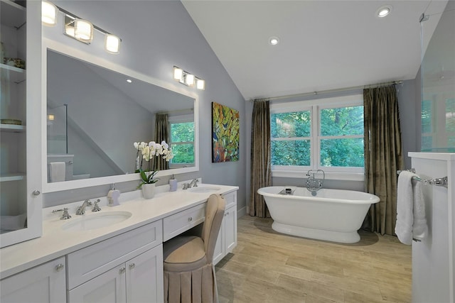 1 Lakeview Rd, South Salem, NY 10590 - bathroom with lofted ceiling, double vanity, a freestanding bath, plenty of natural light, and wood finished floors