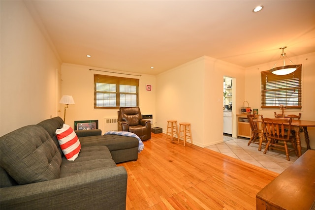 69-27 210th St Unit 2, Oakland Gardens, NY 11364 - living area featuring radiator, healthy amount of natural light, crown molding, light wood-style flooring, and recessed lighting