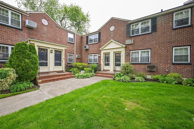69-27 210th St Unit 2, Oakland Gardens, NY 11364 - view of front facade with brick siding, a front yard, and a wall unit AC