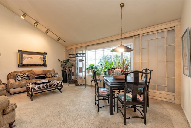 1055 Cedarhurst St, North Woodmere, NY 11581 - dining space featuring light colored carpet, vaulted ceiling, and rail lighting