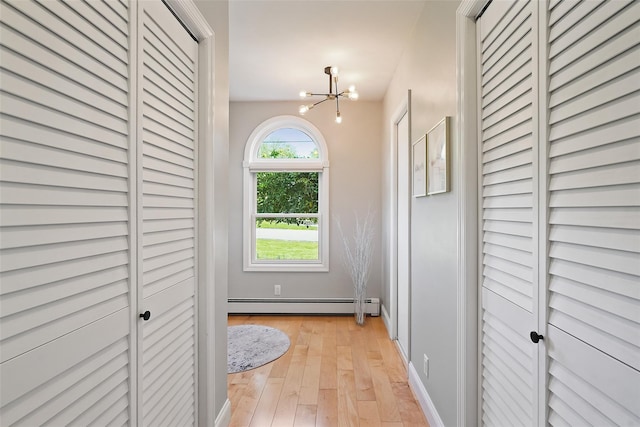 801 Syska Rd, Ossining, NY 10562 - hall with baseboard heating, a chandelier, light wood-style flooring, and baseboards