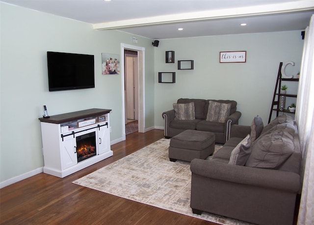 31 Saint Joseph Ave, Ronkonkoma, NY 11779 - living room with dark wood finished floors, recessed lighting, baseboards, and a warm lit fireplace