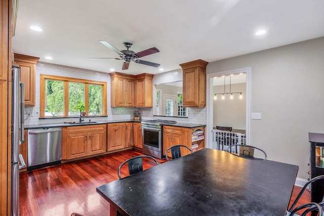 8 Bridle Path Rd, Smithtown, NY 11787 - kitchen featuring stainless steel appliances, a sink, dark wood-style flooring, ceiling fan, and dark countertops