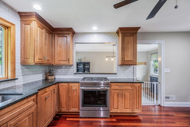 8 Bridle Path Rd, Smithtown, NY 11787 - kitchen with gas stove, dark wood-style flooring, decorative backsplash, ceiling fan, and brown cabinetry