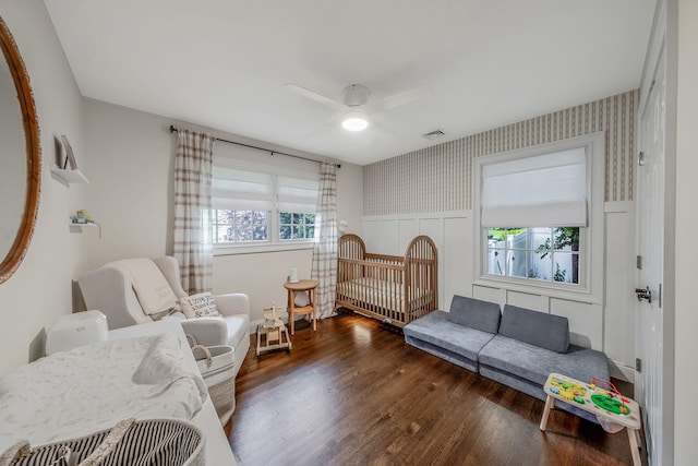 8 Bridle Path Rd, Smithtown, NY 11787 - bedroom with wallpapered walls, wainscoting, wood finished floors, and ceiling fan
