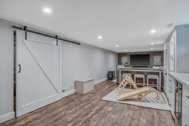 8 Bridle Path Rd, Smithtown, NY 11787 - office space with a barn door, wood finished floors, baseboards, recessed lighting, and wine cooler